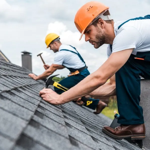 Roofing contractors installing asphalt shingles on a residential roof in Louisville, KY